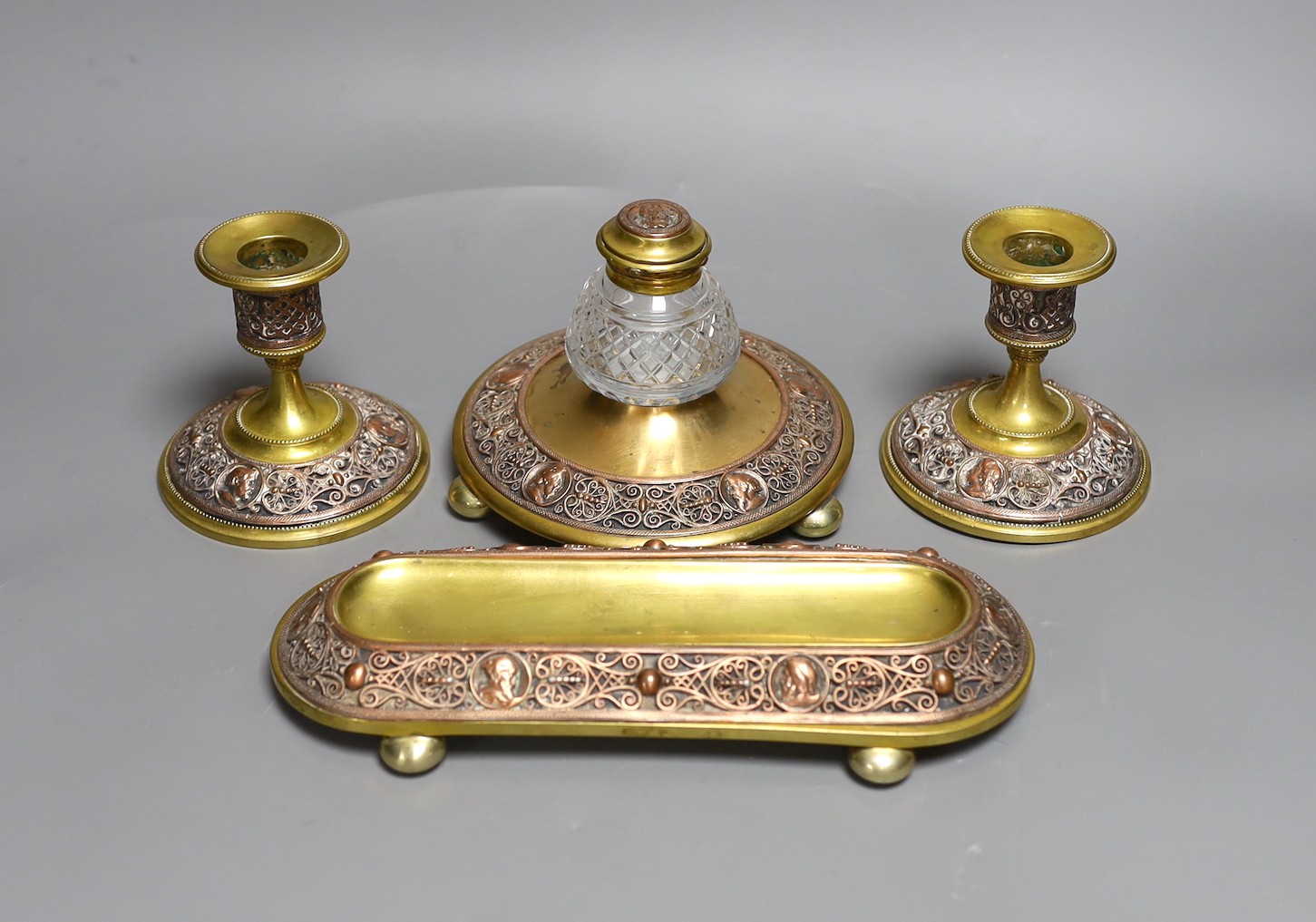 A brass and filigree worked copper desk set (4), inkwell 10.5 cms high